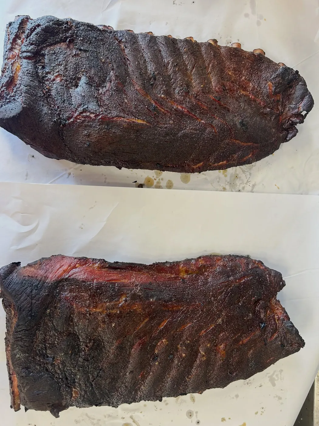 Two smoked racks of ribs on butcher paper